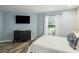 Charming bedroom with a metal bed frame, dresser, and window with curtains at 162 High Hammock Villas, Seabrook Island, SC 29455