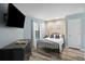 Bright bedroom featuring a comfortable bed, large TV, and plenty of natural light at 162 High Hammock Villas, Seabrook Island, SC 29455