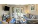 Bright living room with patio access, comfy seating and hardwood floors at 162 High Hammock Villas, Seabrook Island, SC 29455