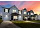 Exterior view of the townhouse featuring attached garages and well-lit entrances at 162 Kirkland St, Goose Creek, SC 29445