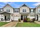 Two-story tan townhome with a front porch, landscaping, and a 2-car garage at 162 Kirkland St, Goose Creek, SC 29445