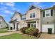 Attractive tan townhome with a front porch and well-manicured landscaping at 162 Kirkland St, Goose Creek, SC 29445