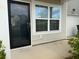 Inviting front entrance featuring a black front door, large window and neutral siding at 162 Kirkland St, Goose Creek, SC 29445
