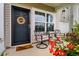 Inviting front porch with seating and vibrant red flowers at 162 Kirkland St, Goose Creek, SC 29445