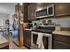Stainless steel appliances and dark brown cabinets in this kitchen at 162 Kirkland St, Goose Creek, SC 29445