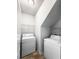 Bright laundry room includes a washing machine, dryer, and wire shelving at 162 Kirkland St, Goose Creek, SC 29445