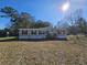 Tan mobile home with wooden deck and spacious yard at 2002 Valnore Rd, Johns Island, SC 29455