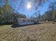 Mobile home exterior with a large yard and trees at 2002 Valnore Rd, Johns Island, SC 29455