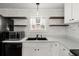 White kitchen cabinets and countertops, plus a farmhouse sink at 2002 Valnore Rd, Johns Island, SC 29455