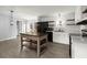 Modern kitchen with white cabinets, wood shelves, and a farmhouse sink at 2002 Valnore Rd, Johns Island, SC 29455