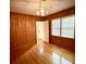 Bedroom with wood paneled walls and hardwood floors at 201 Center St, Walterboro, SC 29488
