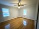 Light blue bedroom with hardwood floors and ceiling fan at 201 Center St, Walterboro, SC 29488