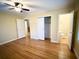 Bedroom with hardwood floors, ceiling fan, and en-suite bathroom at 201 Center St, Walterboro, SC 29488