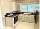 Kitchen with gray cabinets and black countertops at 201 Center St, Walterboro, SC 29488