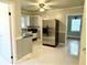 Kitchen with stainless steel refrigerator and tile floor at 201 Center St, Walterboro, SC 29488