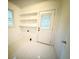 Laundry room with white tile floor and shelving at 201 Center St, Walterboro, SC 29488