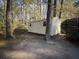 Tan colored storage shed in wooded backyard setting at 201 Center St, Walterboro, SC 29488