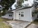 Gray house with a small front porch and a yard at 2351 Elegans Dr, North Charleston, SC 29405