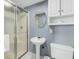 Clean bathroom with pedestal sink, shower, and storage at 2395 Folly Road Rd # 4F, Folly Beach, SC 29439