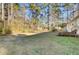 Spacious backyard with grassy area, deck, and mature trees at 250 W Medina St, Summerville, SC 29483