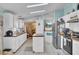 Open kitchen boasts white cabinets, stainless steel appliances, and a butcher block island at 250 W Medina St, Summerville, SC 29483