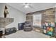 Cozy sitting room features a recliner, built-in shelving, and wood-look flooring at 250 W Medina St, Summerville, SC 29483