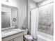Bathroom with granite vanity, shower/tub combo, and tiled walls at 3204 Cross Vine Ln, Summerville, SC 29483
