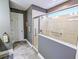 Walk-in shower with grab bars and tiled walls in main bathroom at 3204 Cross Vine Ln, Summerville, SC 29483
