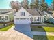 White house with gray roof, American flag, and a 2-car garage at 3204 Cross Vine Ln, Summerville, SC 29483