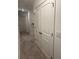 Upstairs hallway with neutral carpeting and double doors at 493 Trotters Ln # 116, Moncks Corner, SC 29461