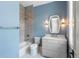 Bright bathroom featuring patterned tile flooring and a shower-tub combo at 6045 Honey Hole Haven, Johns Island, SC 29455