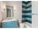 Stylish bathroom showcasing a blue tiled shower and a vanity with a decorative mirror at 6045 Honey Hole Haven, Johns Island, SC 29455