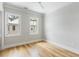 Cozy bedroom with hardwood floors, two windows, and neutral wall colors at 6045 Honey Hole Haven, Johns Island, SC 29455