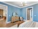 Bright bedroom featuring hardwood floors, modern light fixture, and cozy seating area at 6045 Honey Hole Haven, Johns Island, SC 29455
