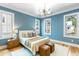 Sunlit bedroom with hardwood floors, white trim, and windows offering neighborhood views at 6045 Honey Hole Haven, Johns Island, SC 29455