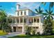Two-story home with a metal roof, porch, and two-car garage at 6045 Honey Hole Haven, Johns Island, SC 29455