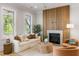 Stylish living room features hardwood floors, a modern fireplace, neutral decor, and comfortable seating with natural light from large windows at 6045 Honey Hole Haven, Johns Island, SC 29455
