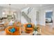 Bright living room connects kitchen, dining, and staircase featuring hardwood floors, comfortable seating, and ample natural light at 6045 Honey Hole Haven, Johns Island, SC 29455