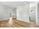 Spacious room with hardwood floors, neutral walls, and multiple doorways leading to other areas at 6045 Honey Hole Haven, Johns Island, SC 29455