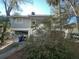 Side view of gray house with white stairs and mature landscaping at 61 Twin Oaks Ln, Isle of Palms, SC 29451