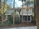 Gray two-story house with white trim, elevated foundation, and surrounding trees at 61 Twin Oaks Ln, Isle of Palms, SC 29451
