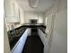 Galley kitchen with white cabinets, granite countertops, and stainless steel appliances at 61 Twin Oaks Ln, Isle of Palms, SC 29451