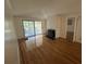Hardwood floor living room with fireplace and sliding glass doors to deck at 61 Twin Oaks Ln, Isle of Palms, SC 29451