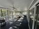 Screened porch with seating and ceiling fan at 61 Twin Oaks Ln, Isle of Palms, SC 29451