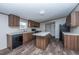 Spacious kitchen island, granite countertops, and dark wood cabinets at 68 Kickback Cv, Round O, SC 29474