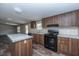 Kitchen with black appliances, granite countertops, and ample cabinet space at 68 Kickback Cv, Round O, SC 29474