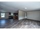 Open living room with kitchen and dark laminate floors at 68 Kickback Cv, Round O, SC 29474