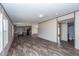 Open living room features wood-look floors and views into the kitchen and bathroom at 68 Kickback Cv, Round O, SC 29474