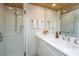 Walk-in shower, modern vanity with white cabinets, and white countertop at 7 Dunecrest Trace, Seabrook Island, SC 29455
