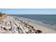 Oceanfront property with rocky shoreline and sandy beach at 7 Dunecrest Trace, Seabrook Island, SC 29455